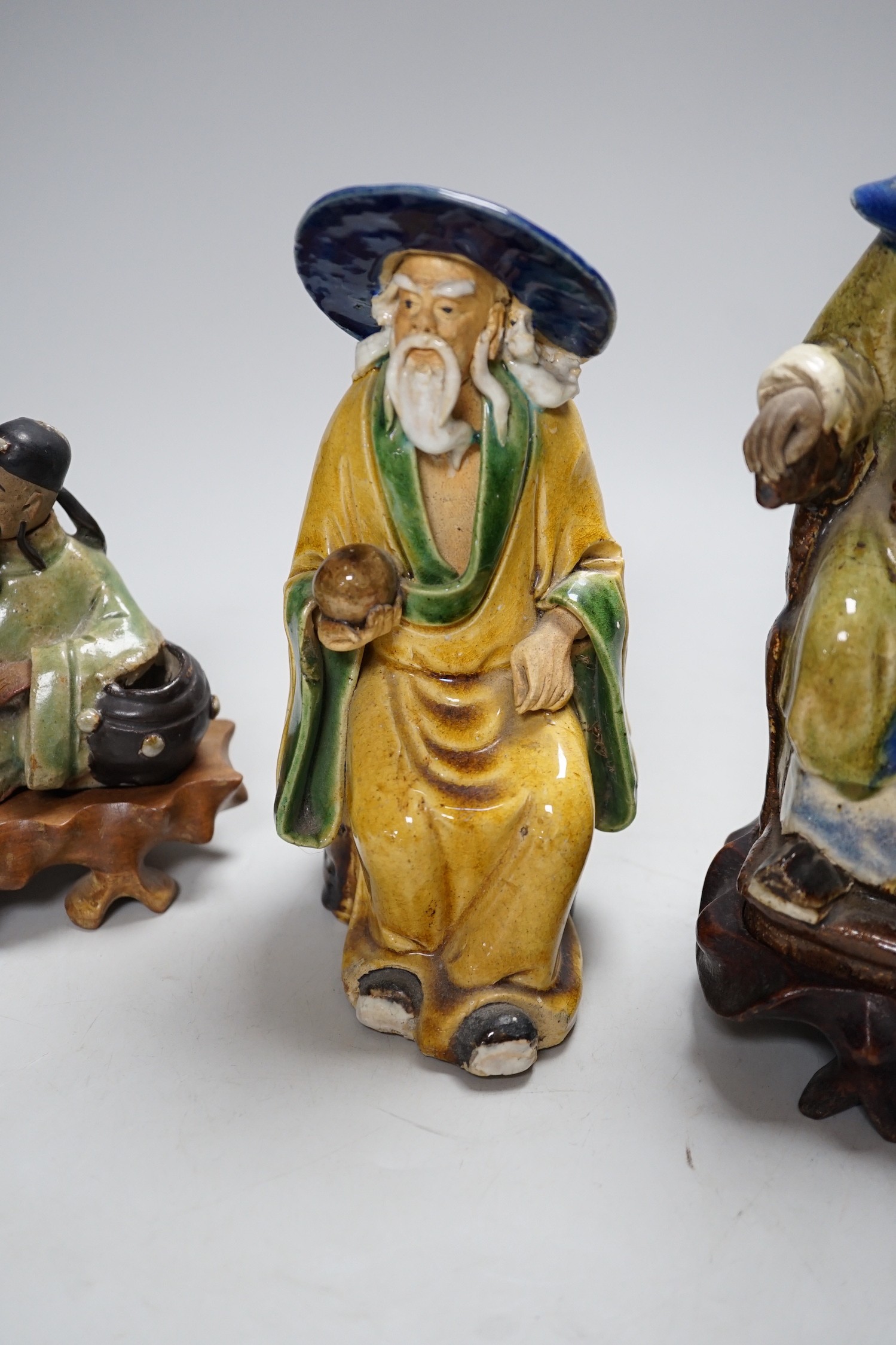 Three Chinese Shiwan pottery figures of an Emperor, Li Bai and an old man, tallest 23cm